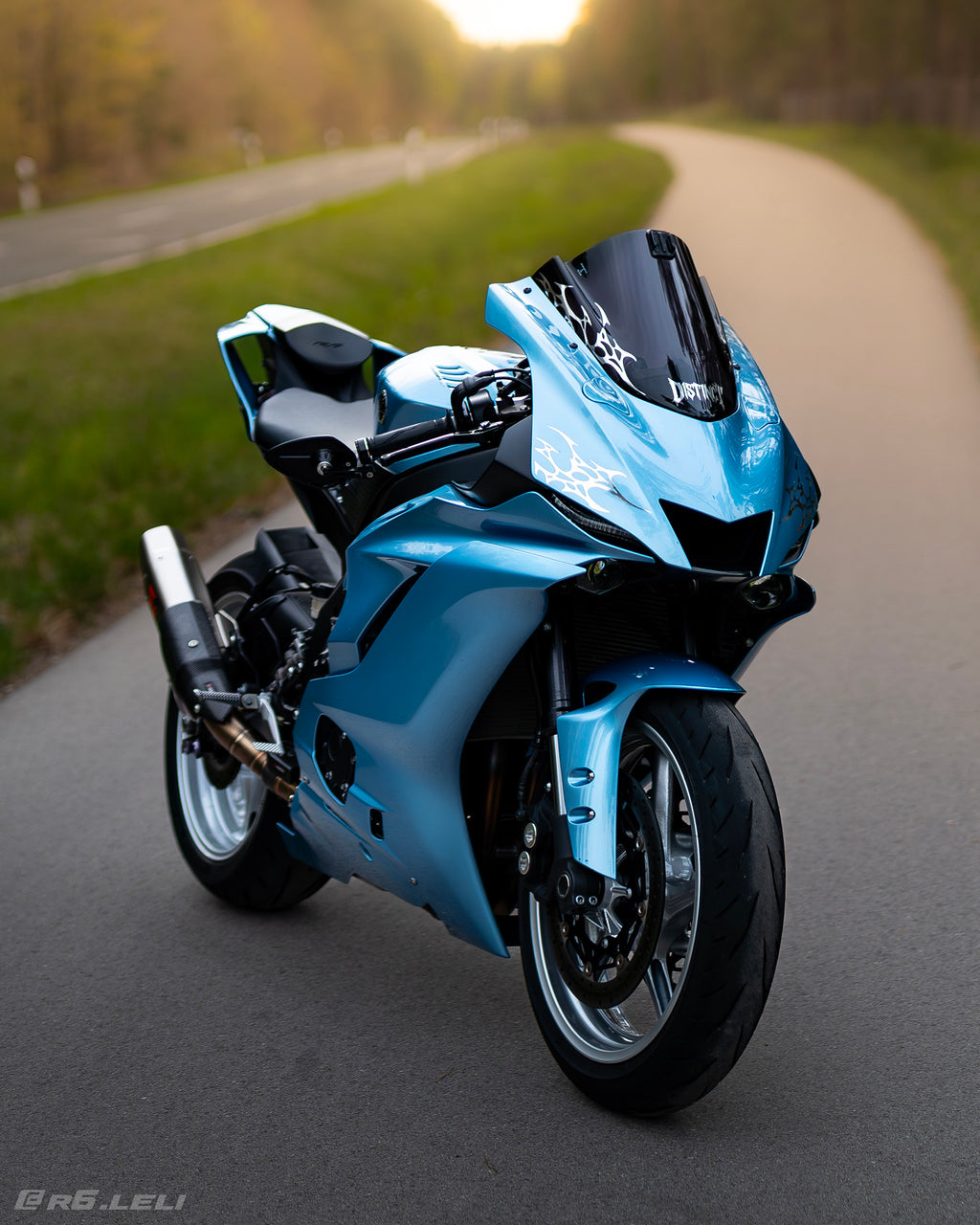 Close-up of premium blue with chrome neo-tribal decal on a motorcycle windshield - DISTINCT