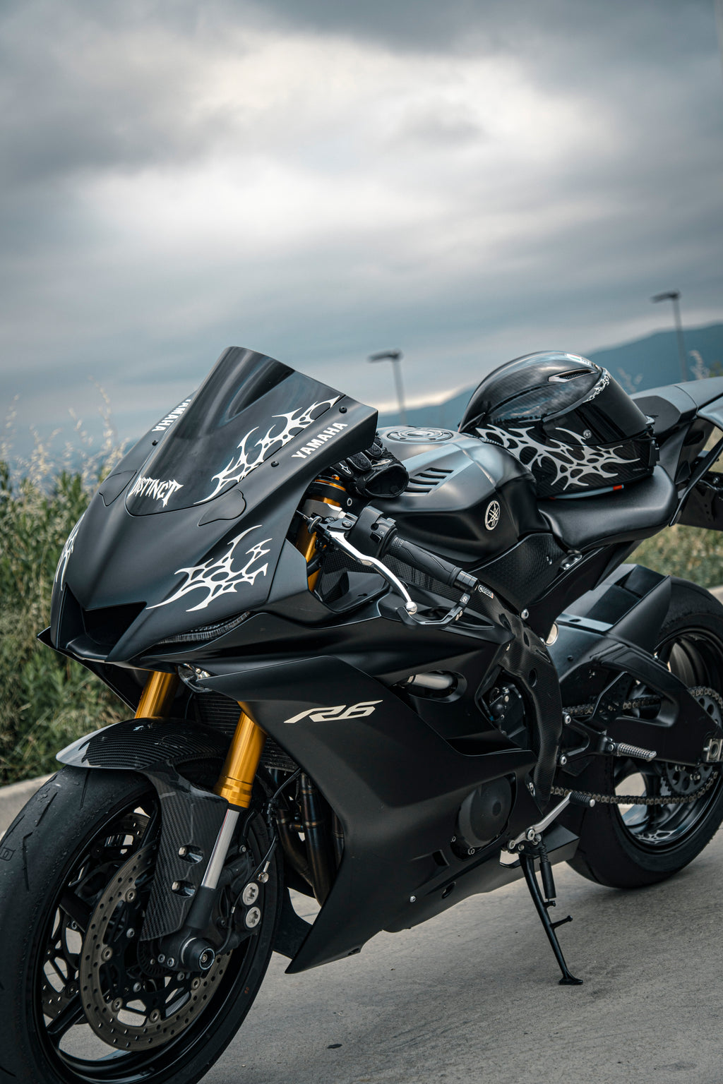 Close-up of premium white reflectant neo-tribal decal on a r6 motorcycle windshield and helmet agv pista gp rr - DISTINCT